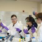 Students in labcoats and goggles