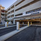 Multi-level parking garage with clear "P7 PARKING" signage and entrance lanes.